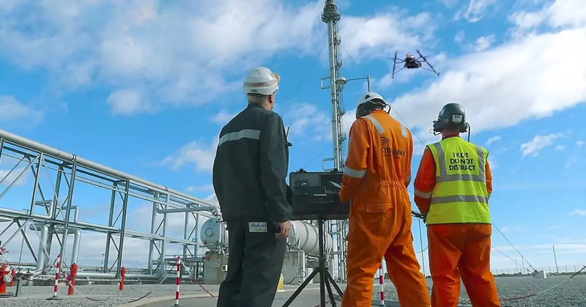 Engineers use a drone to inspect an oil rig for methane emissions. 