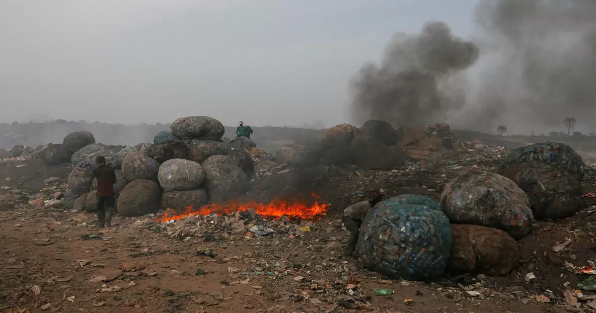 Waste burns at the main dump for Nigeria's capital Abuja. Improving waste management can reduce toxic air pollution and powerful greenhouse gases like methane. . 